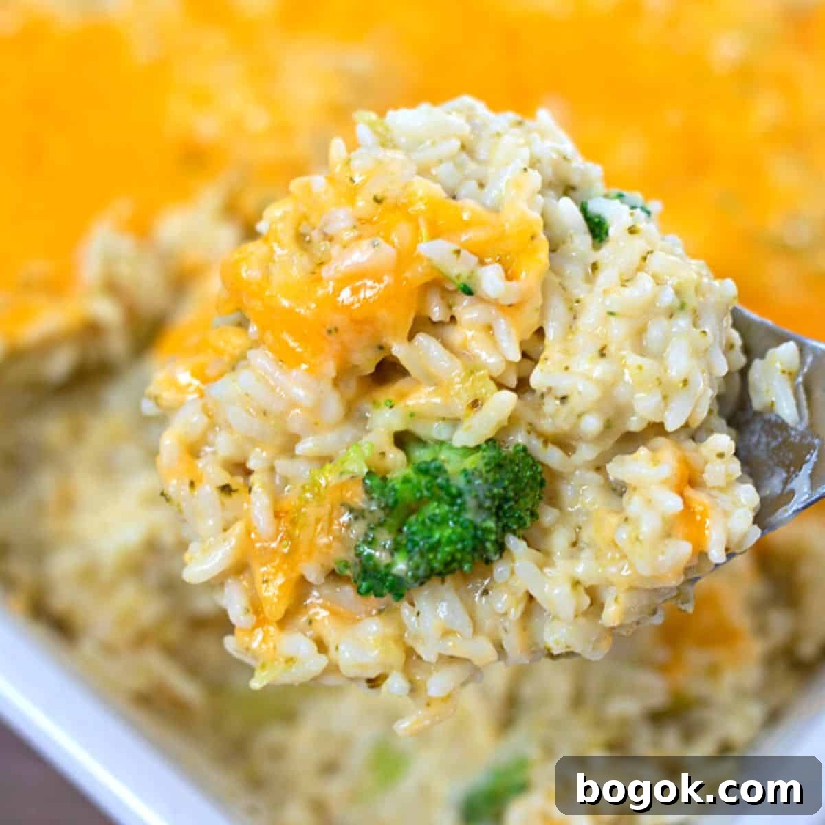 Recipes for Easy Thanksgiving Scoop of homemade broccoli rice casserole with tons of cheese.