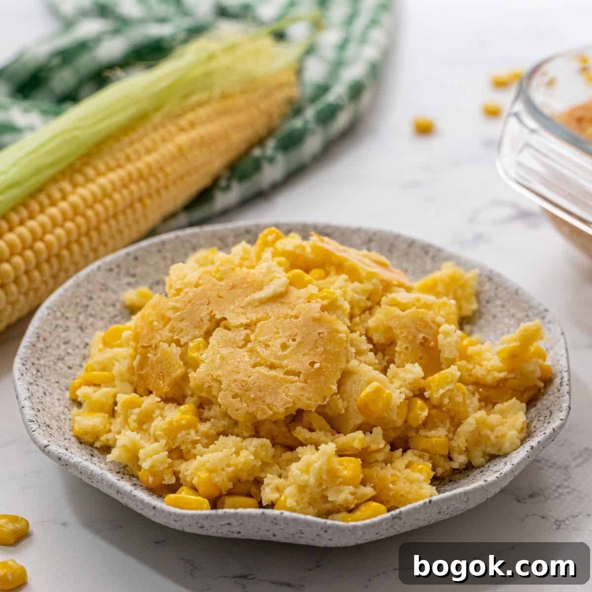 Recipes for an Easy Thanksgiving Plated corn casserole on gray plate.