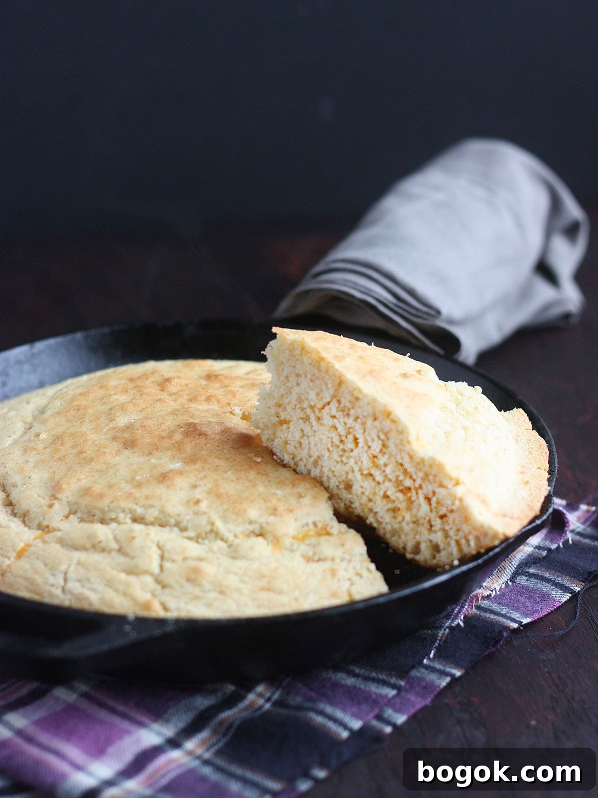 Classic Southern Skillet Cornbread Recipe for Crispy Golden Crust 15 slice of cornmeal cut out and resting on top of a pan of cornbread