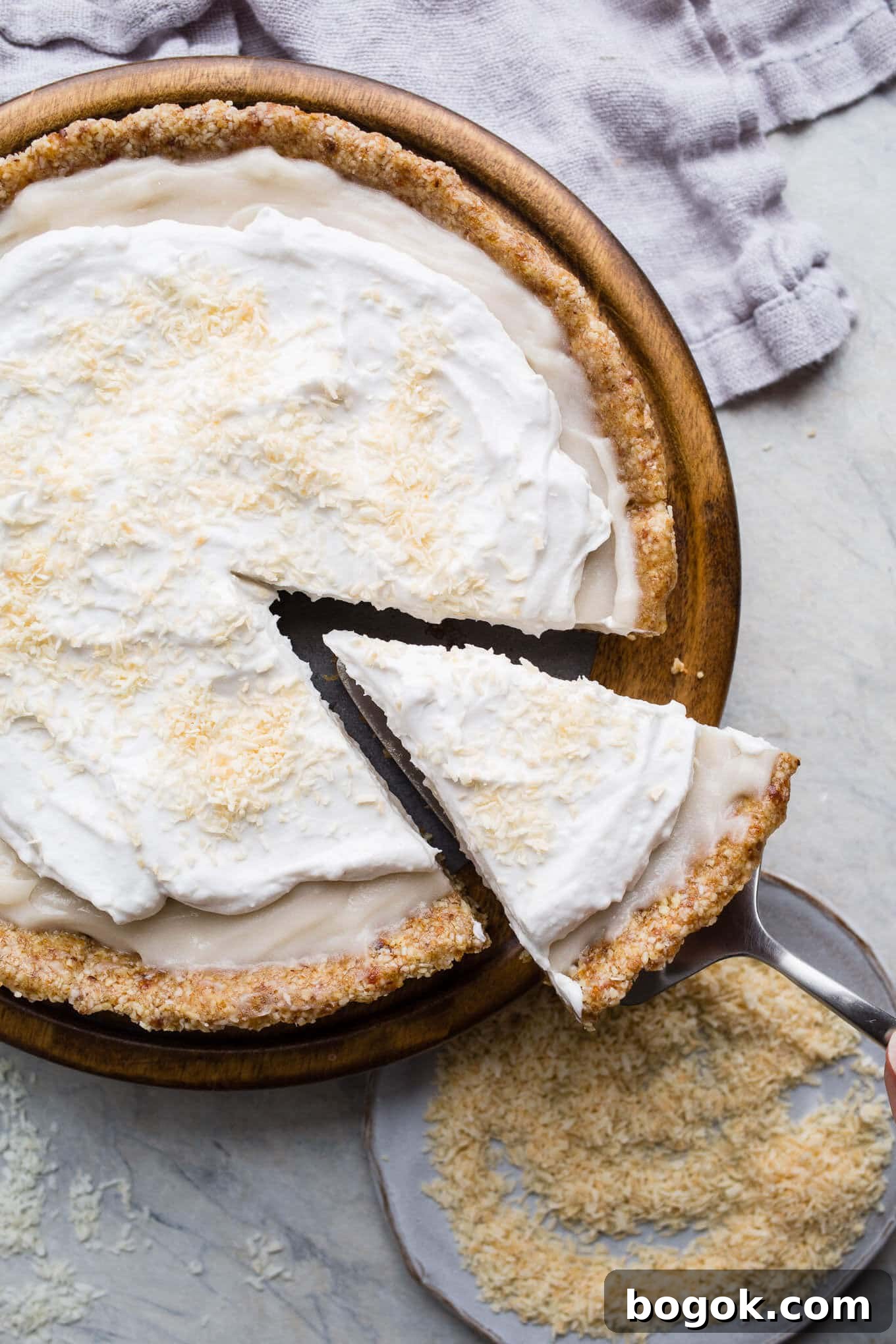 This No-Bake Coconut Cream Pie is made with a sprouted almond press-in crust, coconut milk pudding filling, and topped coconut cream and toasted shredded coconut. Gluten-free, vegan.