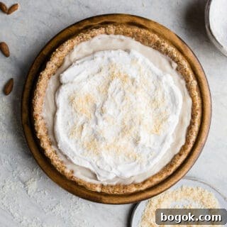 This No-Bake Coconut Cream Pie is made with a sprouted almond press-in crust, coconut milk pudding filling, and topped coconut cream and toasted shredded coconut. Gluten-free, vegan.
