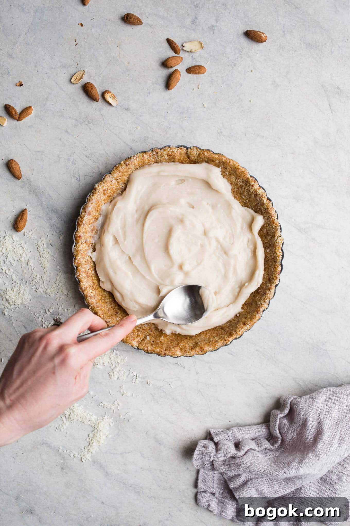This No-Bake Coconut Cream Pie is made with a sprouted almond press-in crust, coconut milk pudding filling, and topped coconut cream and toasted shredded coconut. Gluten-free, vegan.