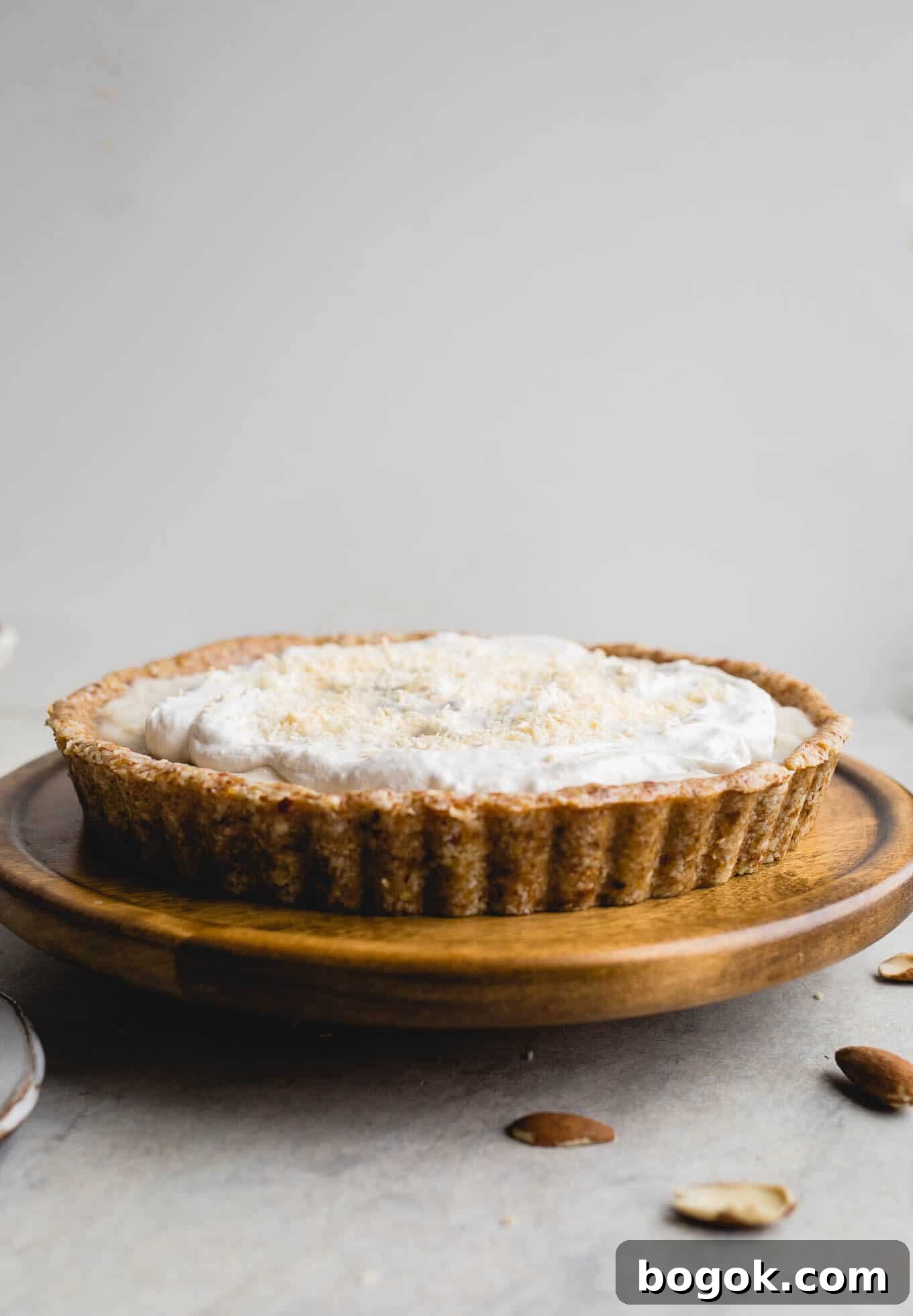 This No-Bake Coconut Cream Pie is made with a sprouted almond press-in crust, coconut milk pudding filling, and topped coconut cream and toasted shredded coconut. Gluten-free, vegan.