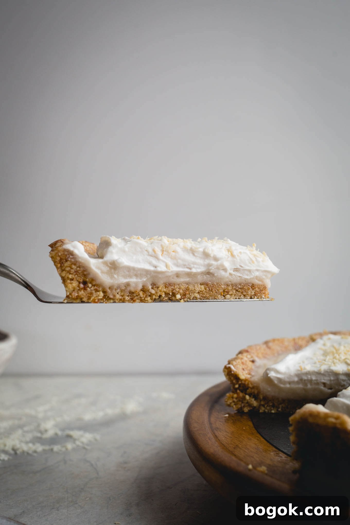This No-Bake Coconut Cream Pie is made with a sprouted almond press-in crust, coconut milk pudding filling, and topped coconut cream and toasted shredded coconut. Gluten-free, vegan.
