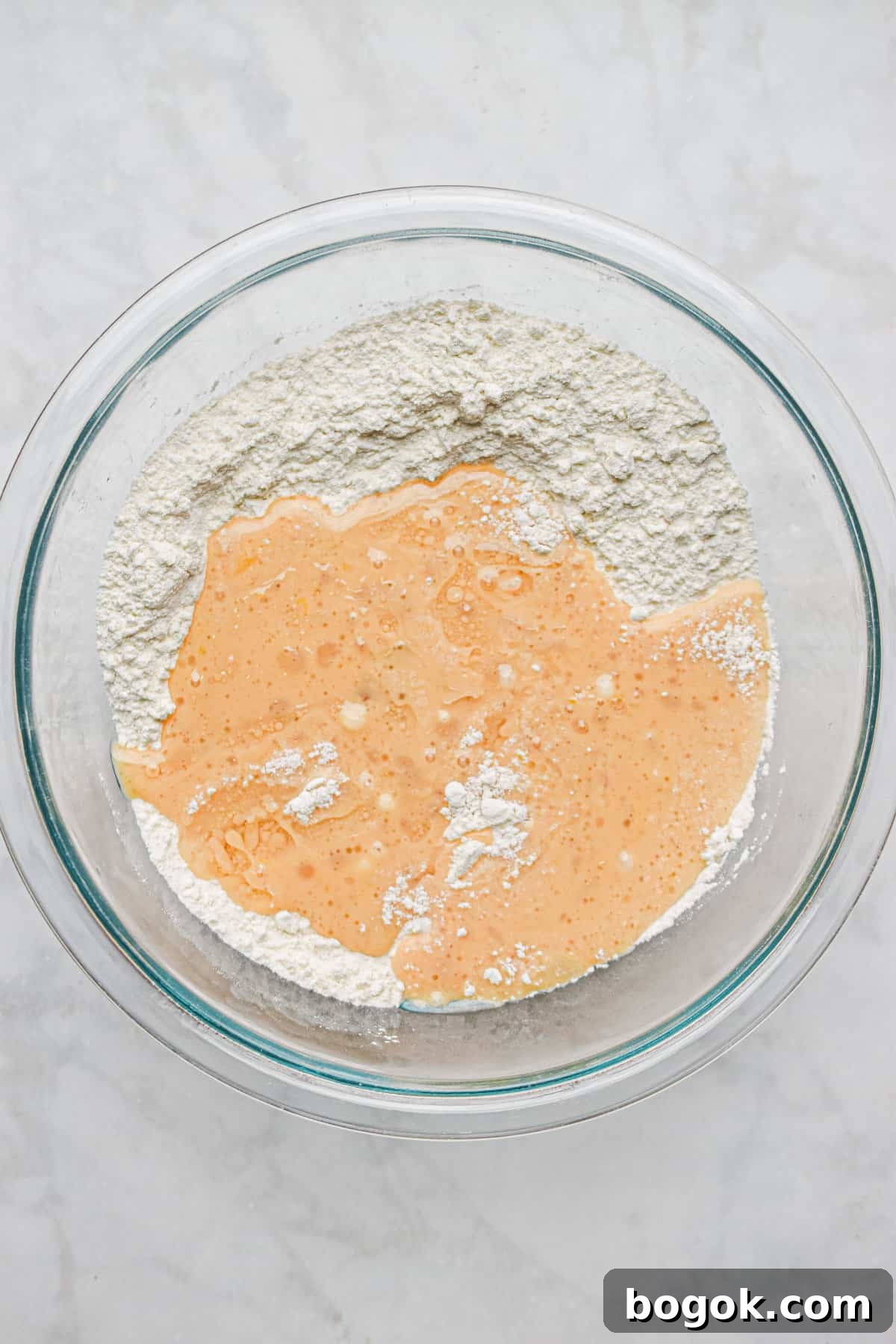 Baked Dairy-Free Peach Donuts Recipe 7 The wet ingredients are added to the mixing bowl with the dry ingredients.