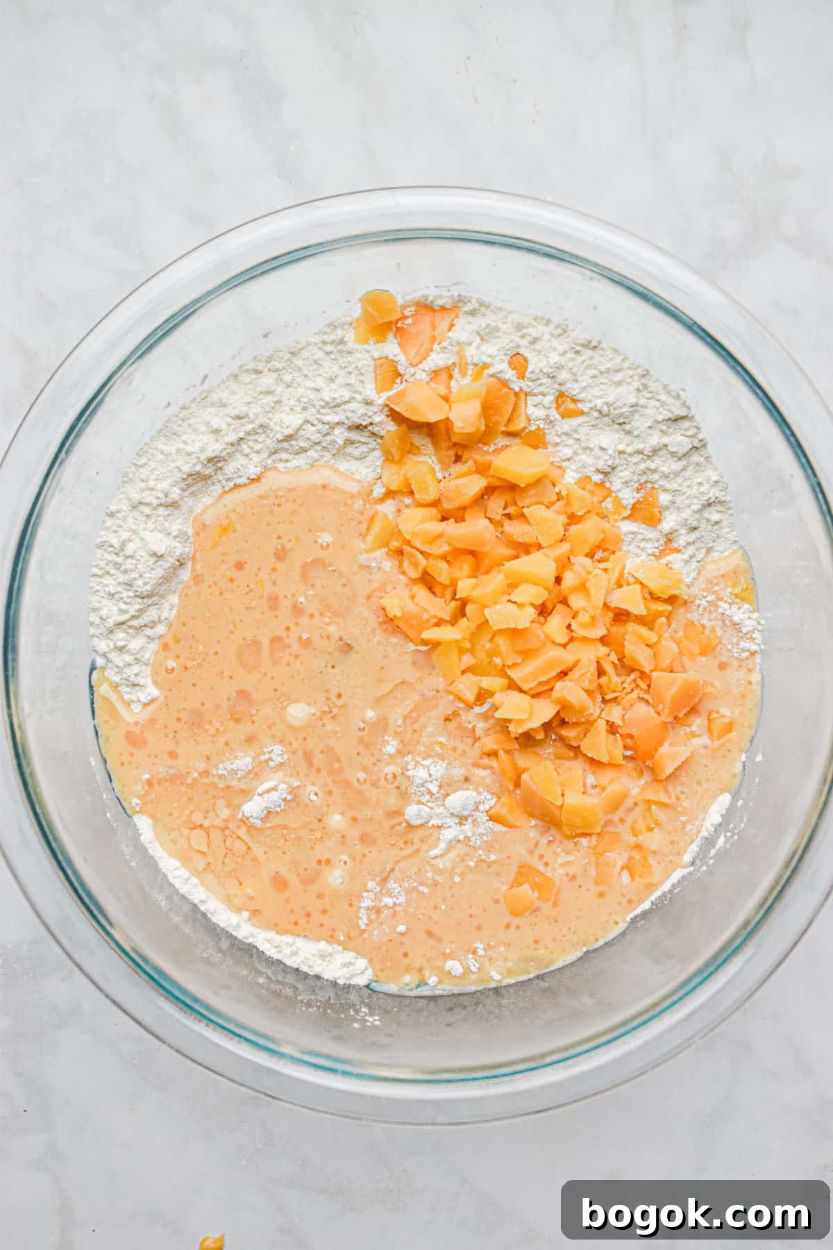 Baked Dairy-Free Peach Donuts Recipe 8 The peaches are added to the bowl with the wet and dry ingredients.