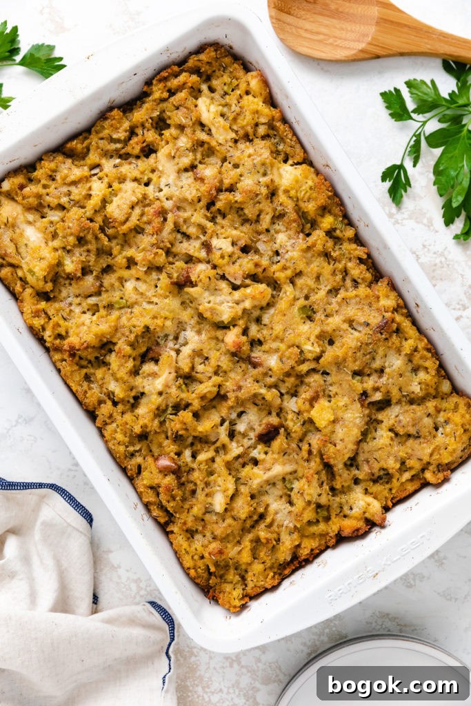 Baked chicken and dressing in a pan.