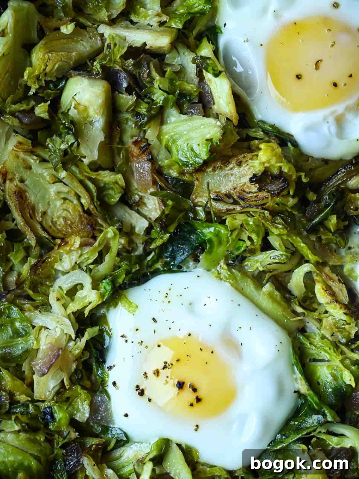 Crispy Brussels Sprout Hash with Bacon and Caramelized Onions 2 Overhead of Brussel sprout hash with 2 eggs.
