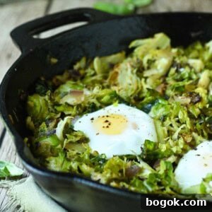 Crispy Brussels Sprout Hash with Bacon and Caramelized Onions 16 Close-up of Brussel sprout hash in a black skillet.