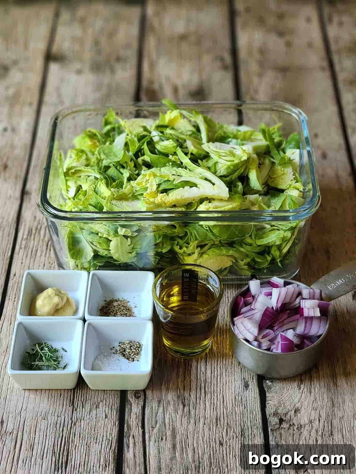 Crispy Brussels Sprout Hash with Bacon and Caramelized Onions 3 Ingredients for Brussel sprout hash on a wood surface.