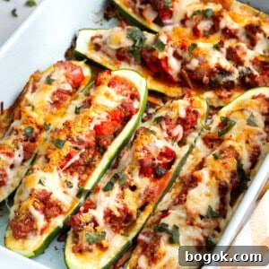 A baking dish full of cheesy stuffed zucchini.