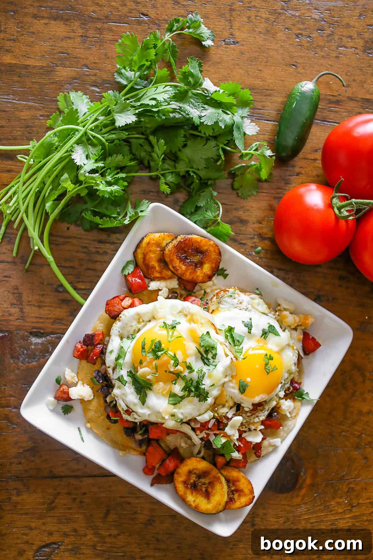 Huevos Motuleños topped with minced cilantro. 