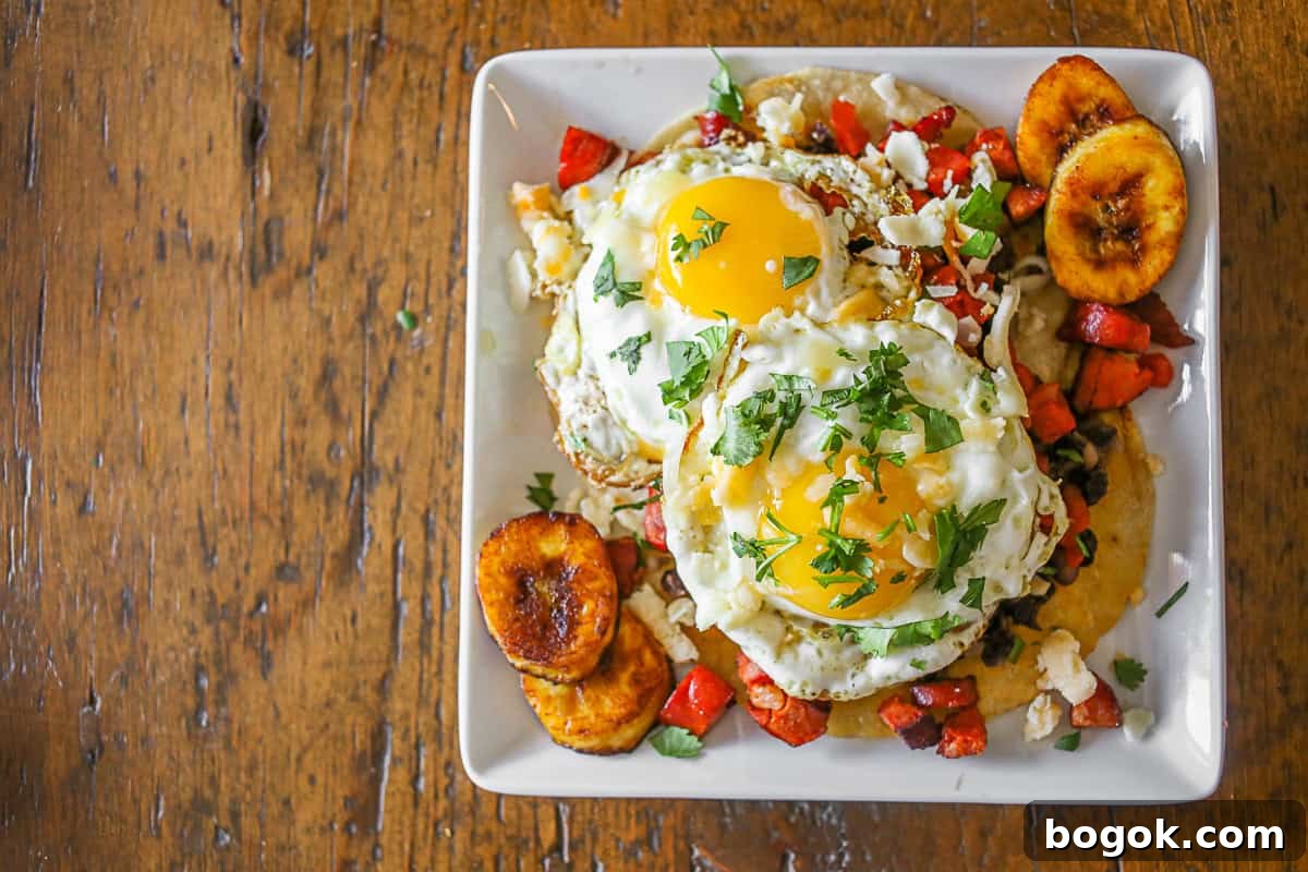 Huevos Motuleños on a small white plate. 
