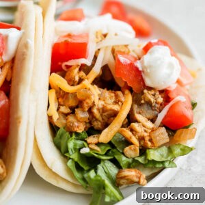 Flavorful Tempeh Tacos with Zesty Avocado Slaw 12 tempeh tacos topped with tomato, cheese, and sour cream
