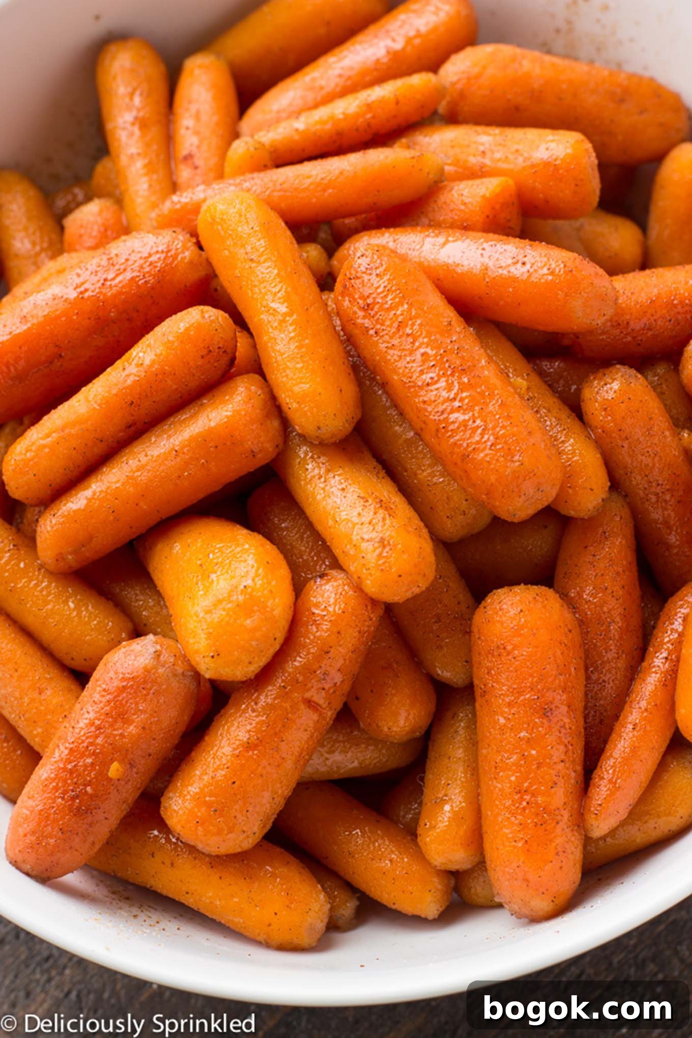 Instant Pot Glazed Carrots in a white bowl/ Brown sugar carrots only use simple ingredients and only takes less than 10 minutes to make. Perfect holiday side dish that everyone will love.