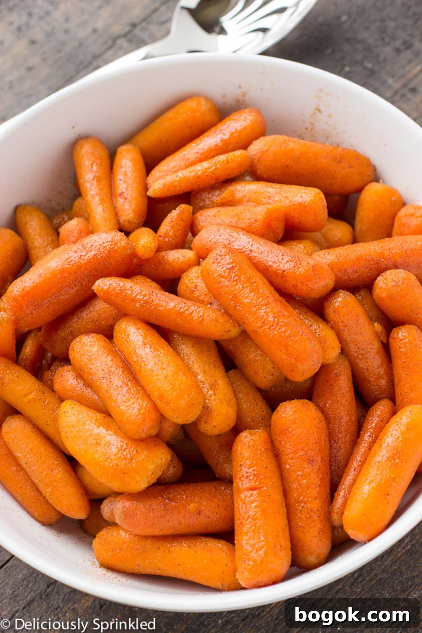 A bowl of brown sugar carrots in a bowl on the table.
