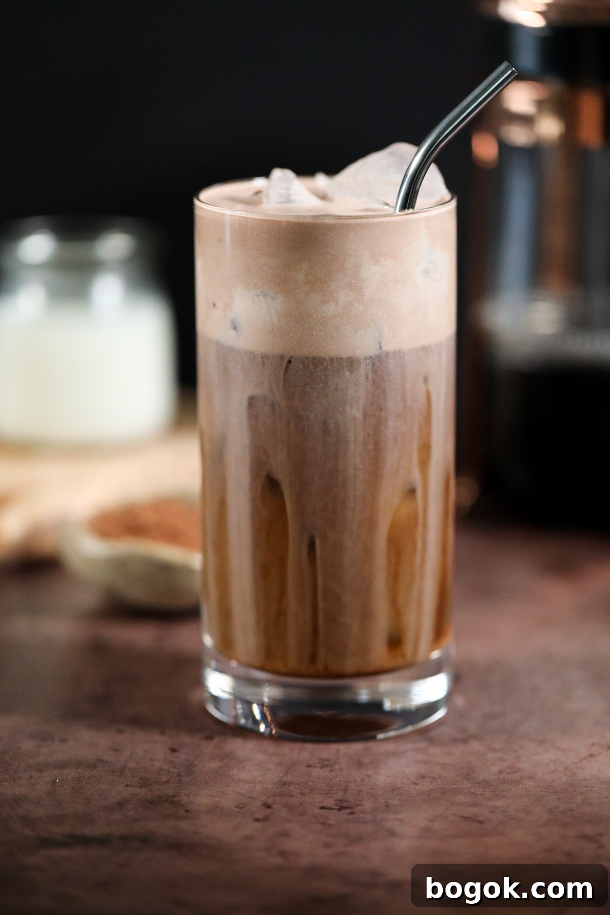 Starbucks-Style Chocolate Cream Cold Brew Recipe 2 chocolate cream cold brew in a glass on a brown surface.