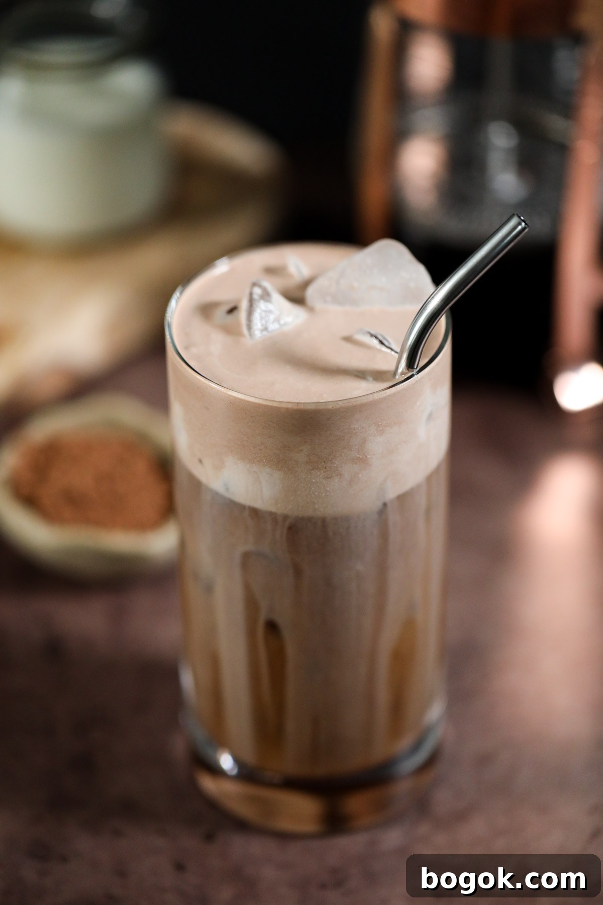 Starbucks-Style Chocolate Cream Cold Brew Recipe 3 chocolate cream cold brew in a glass on a brown surface.