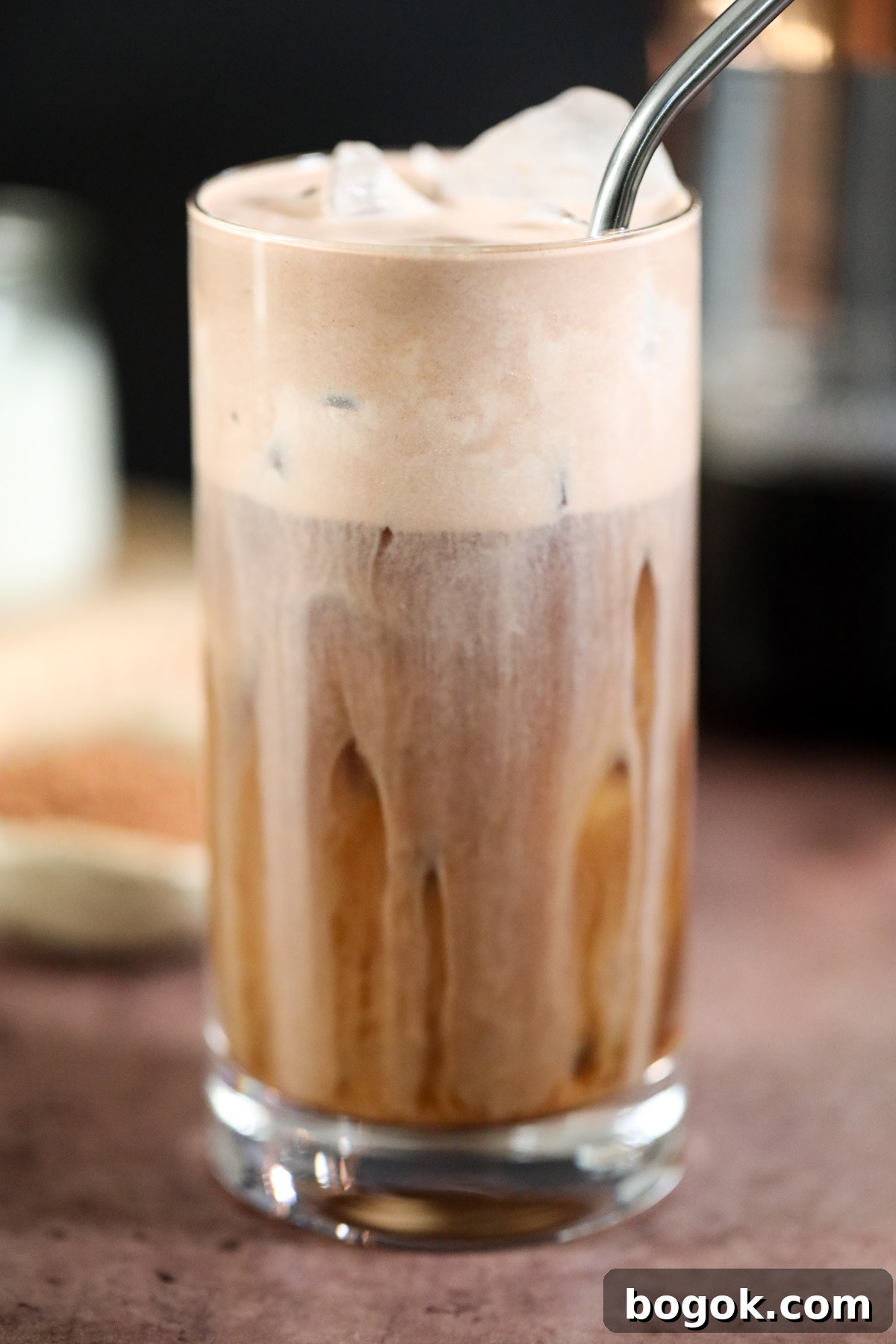 Starbucks-Style Chocolate Cream Cold Brew Recipe 4 chocolate cream cold brew in a glass on a brown surface.