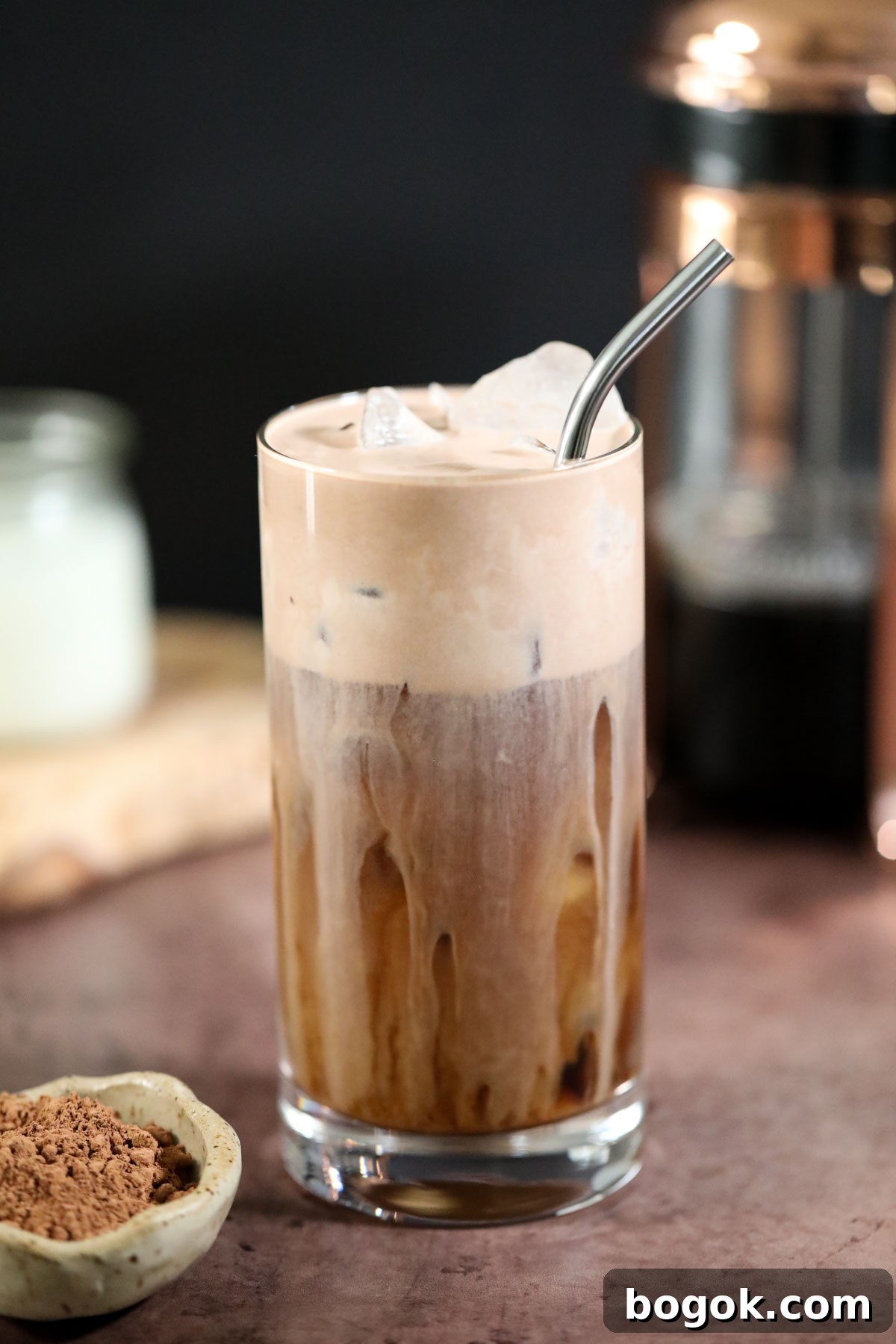 Starbucks-Style Chocolate Cream Cold Brew Recipe 6 chocolate cream cold brew in a glass on a brown surface.
