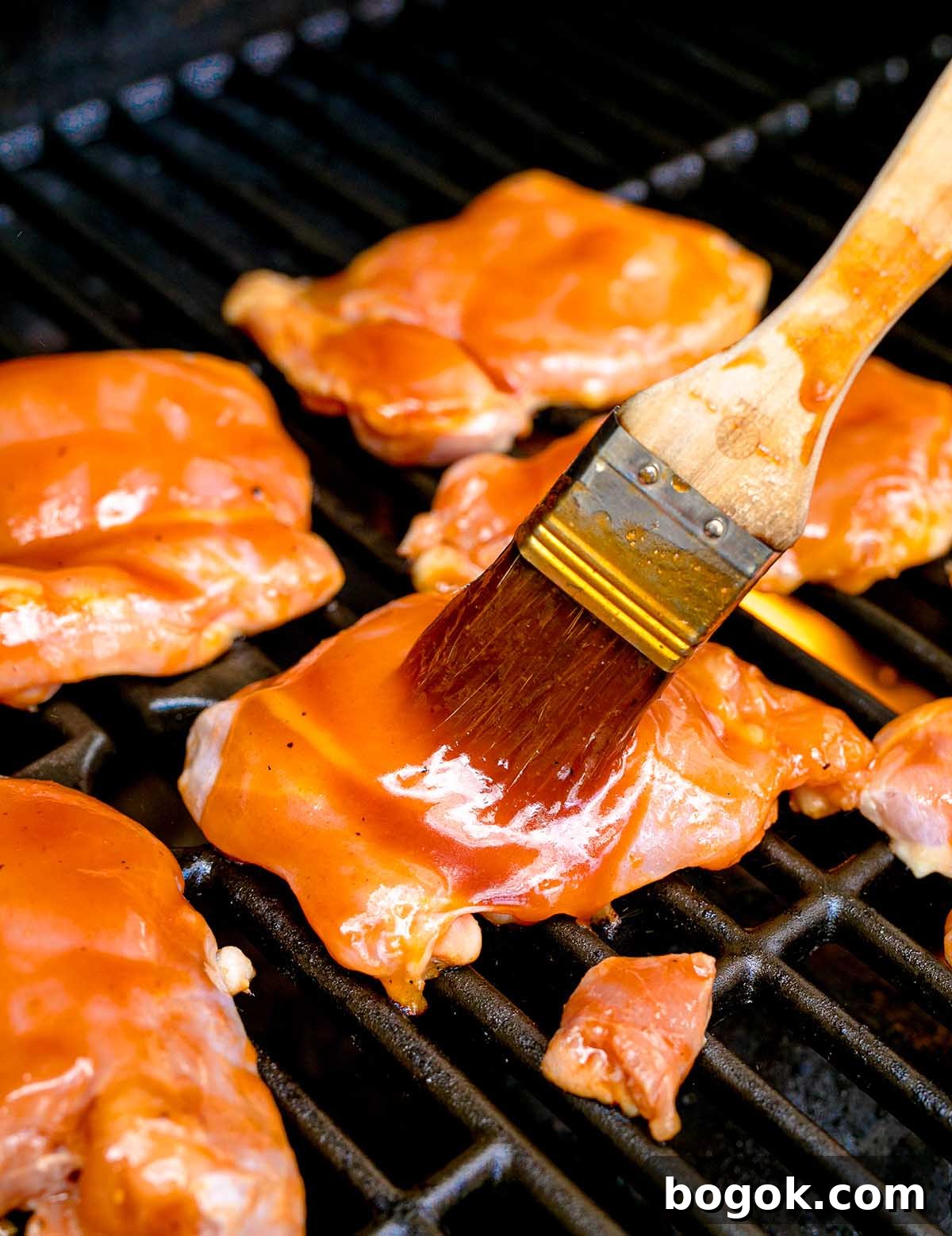 Hawaiian-Style BBQ Chicken with Pineapple Glaze 17 Juicy chicken pieces are brushed with a savory sauce on the grill, capturing the essence of Hawaiian BBQ Chicken in every delicious bite.