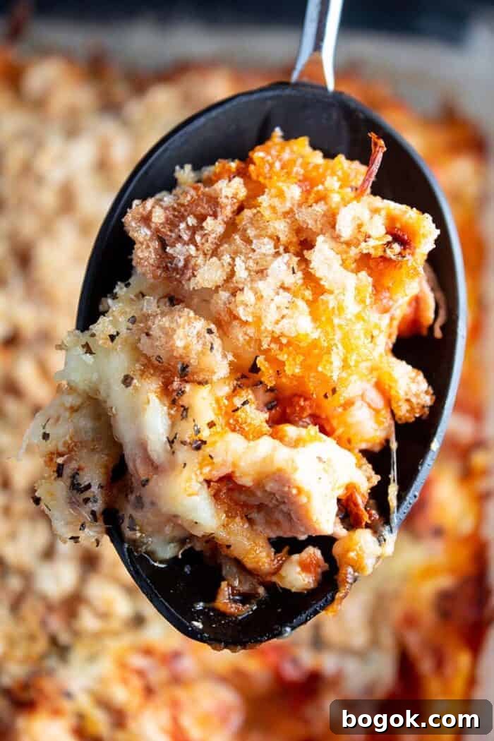 Philly Cheesesteak Keto Lettuce Wraps — Low-Carb Dinner Option 19 overhead view of serving spoon with keto chicken parmesan casserole with casserole in background