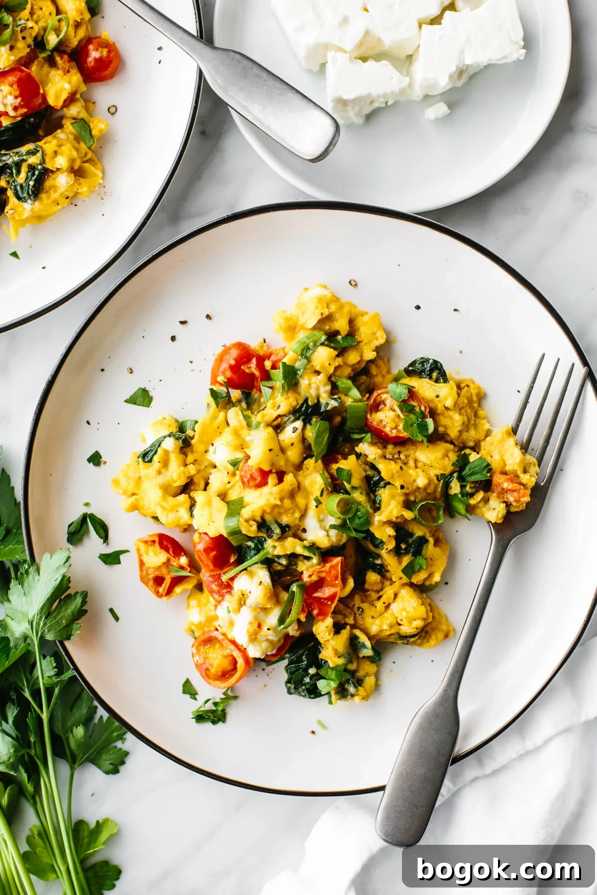 Greek scrambled eggs on a white plate