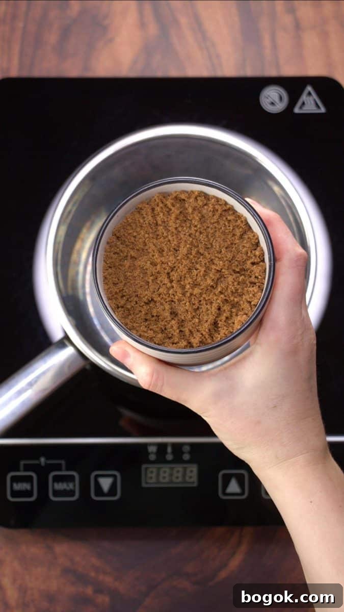 A bowl of brown sugar being added to a sauce pan. Hostess At Heart