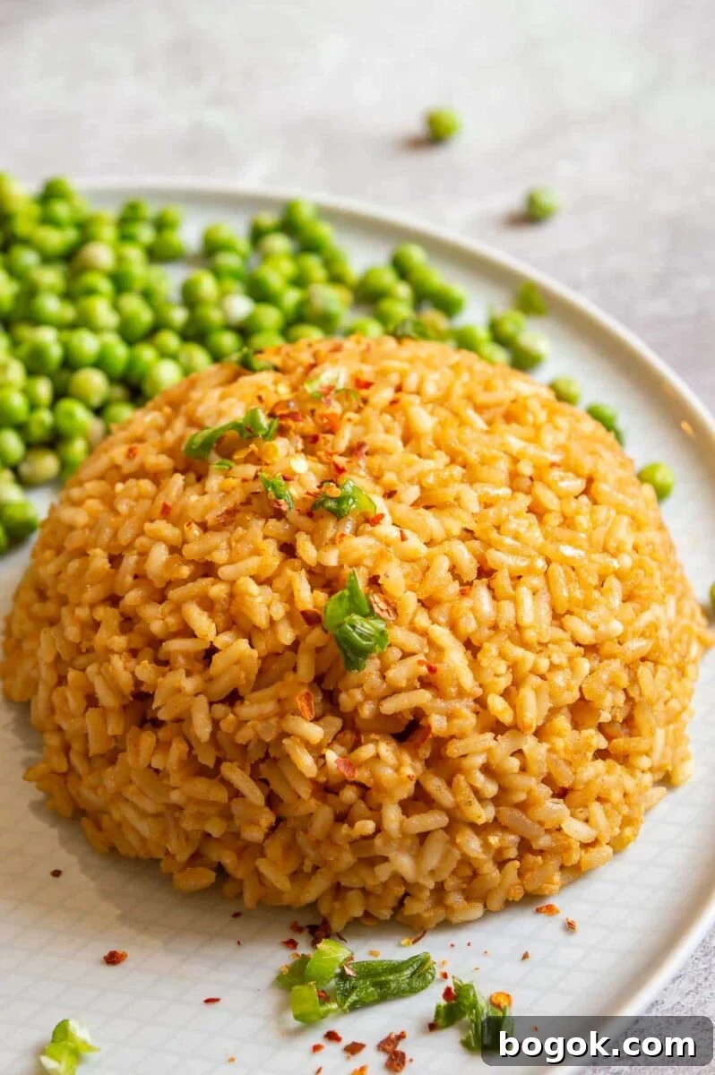 A round mound of rice mixed with peanut butter on a white plate.