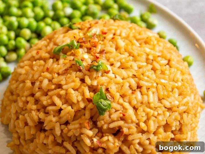 A round mound of rice mixed with peanut butter on a white plate.