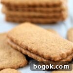 biscoff cookies stacked on parchment paper.
