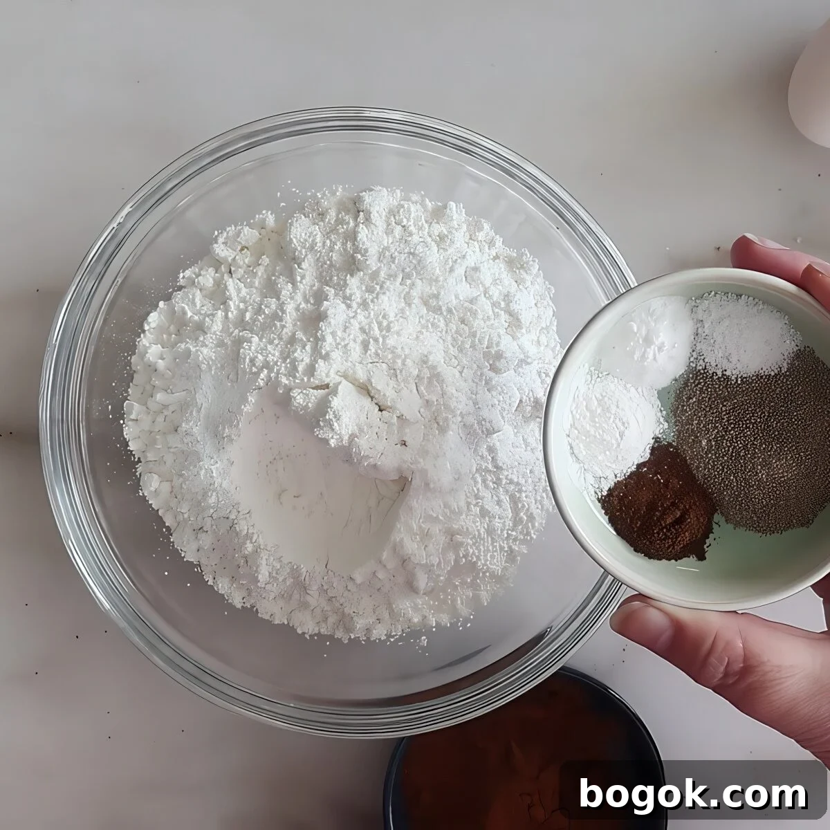 adding spices to flour in small glass bowl.