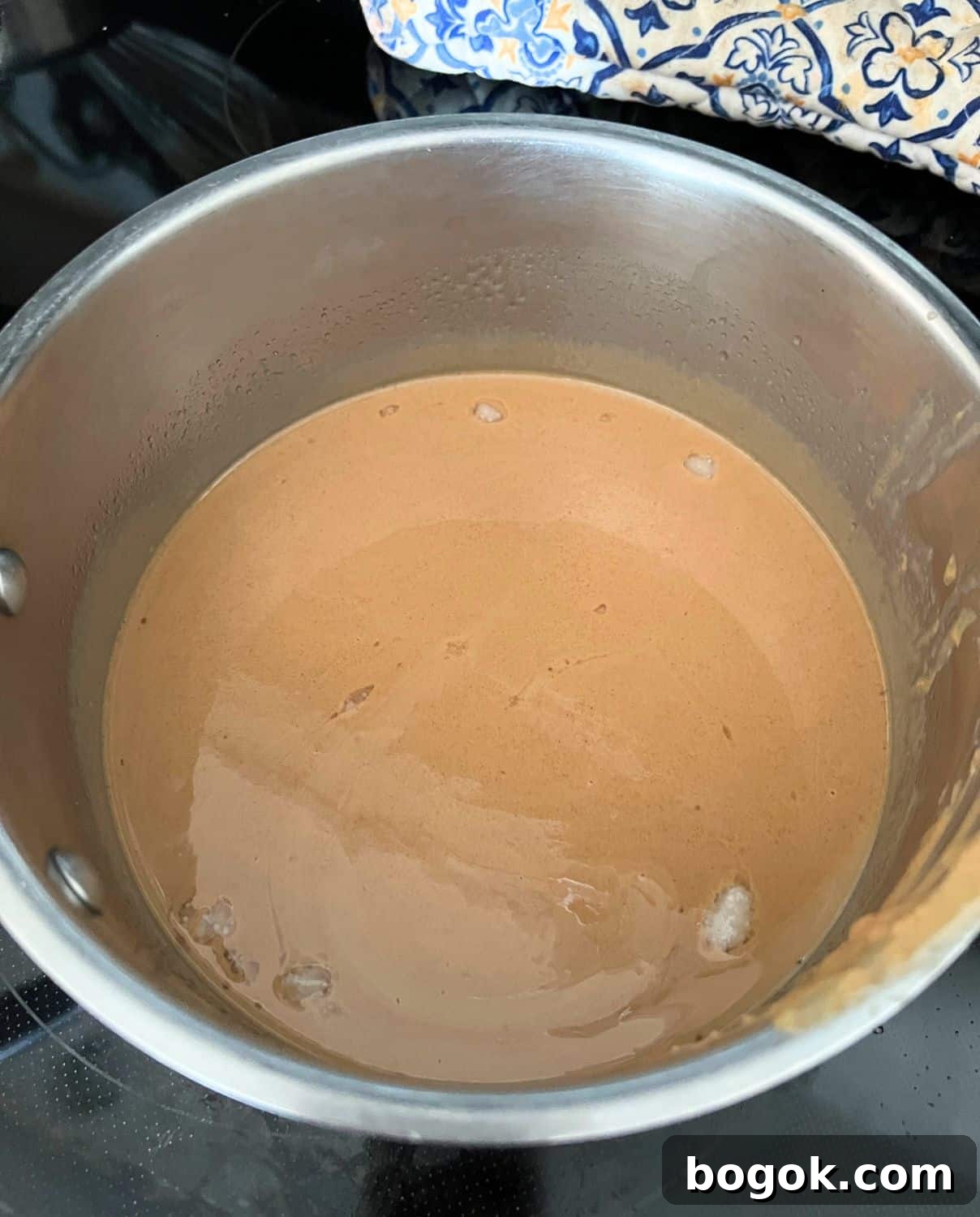Peanut butter, honey, and coconut oil melted in a pot. 