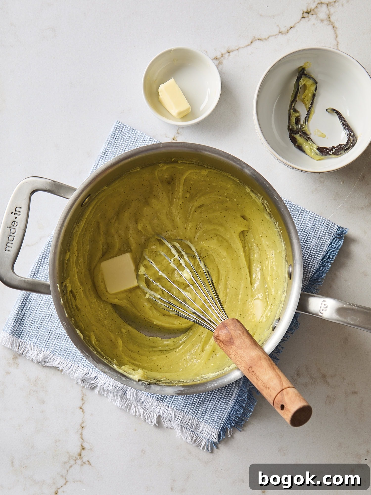 Cooked pastry cream with butter being added.