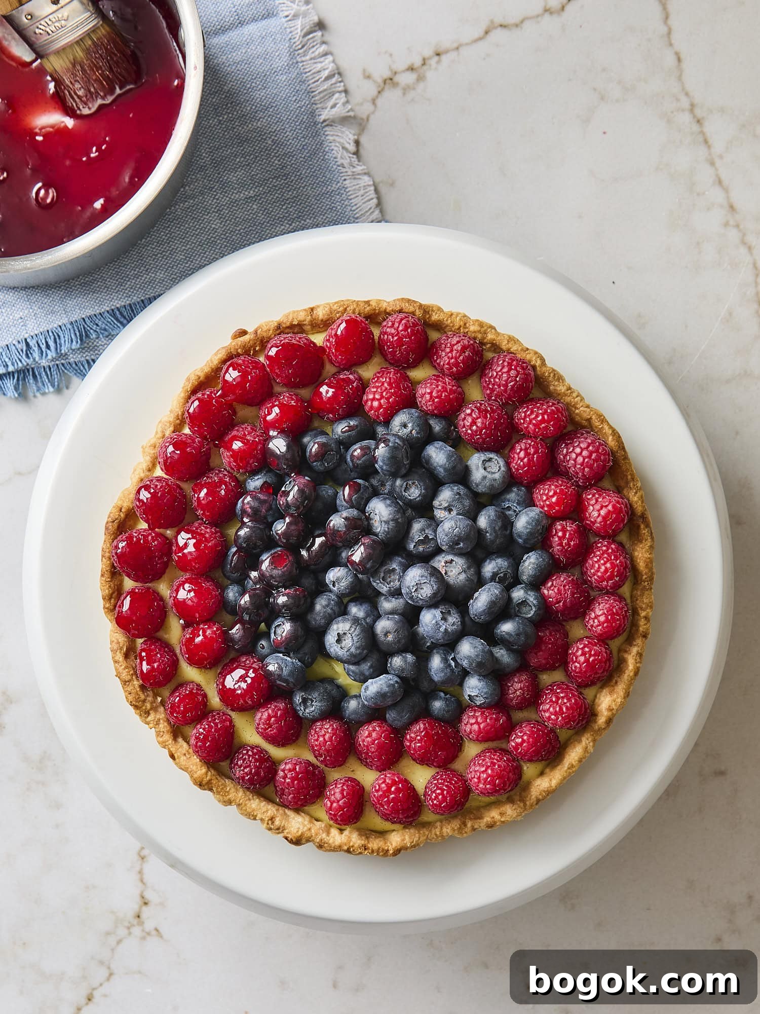 Glazing the top of a fresh fruit tart.