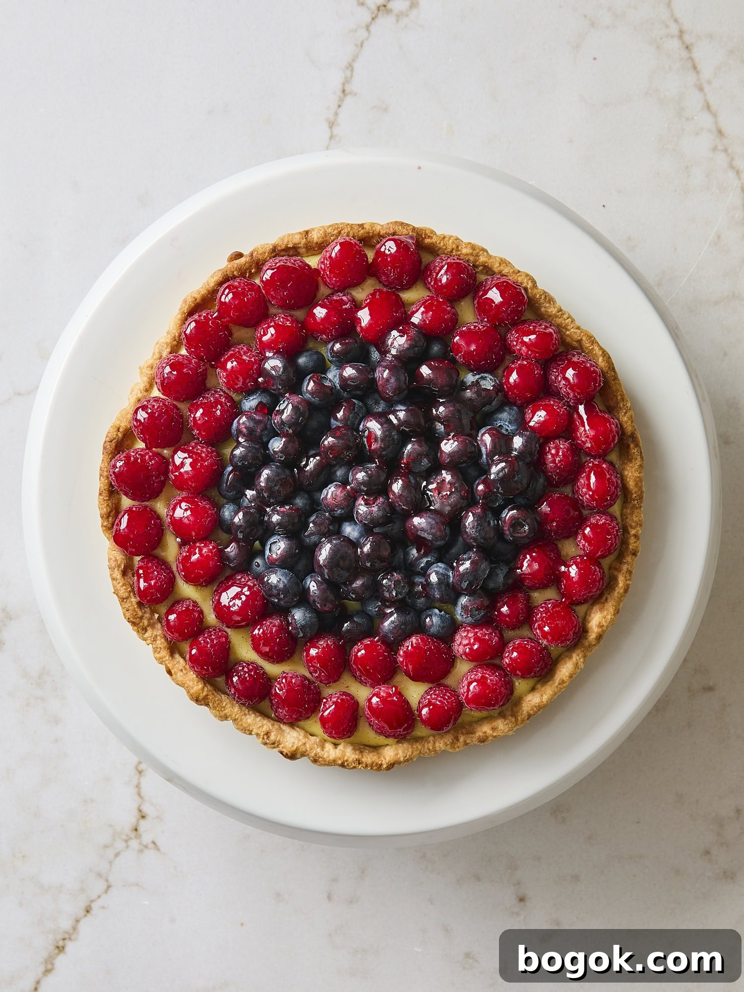 Glazed fresh fruit tart with pastry cream underneath.