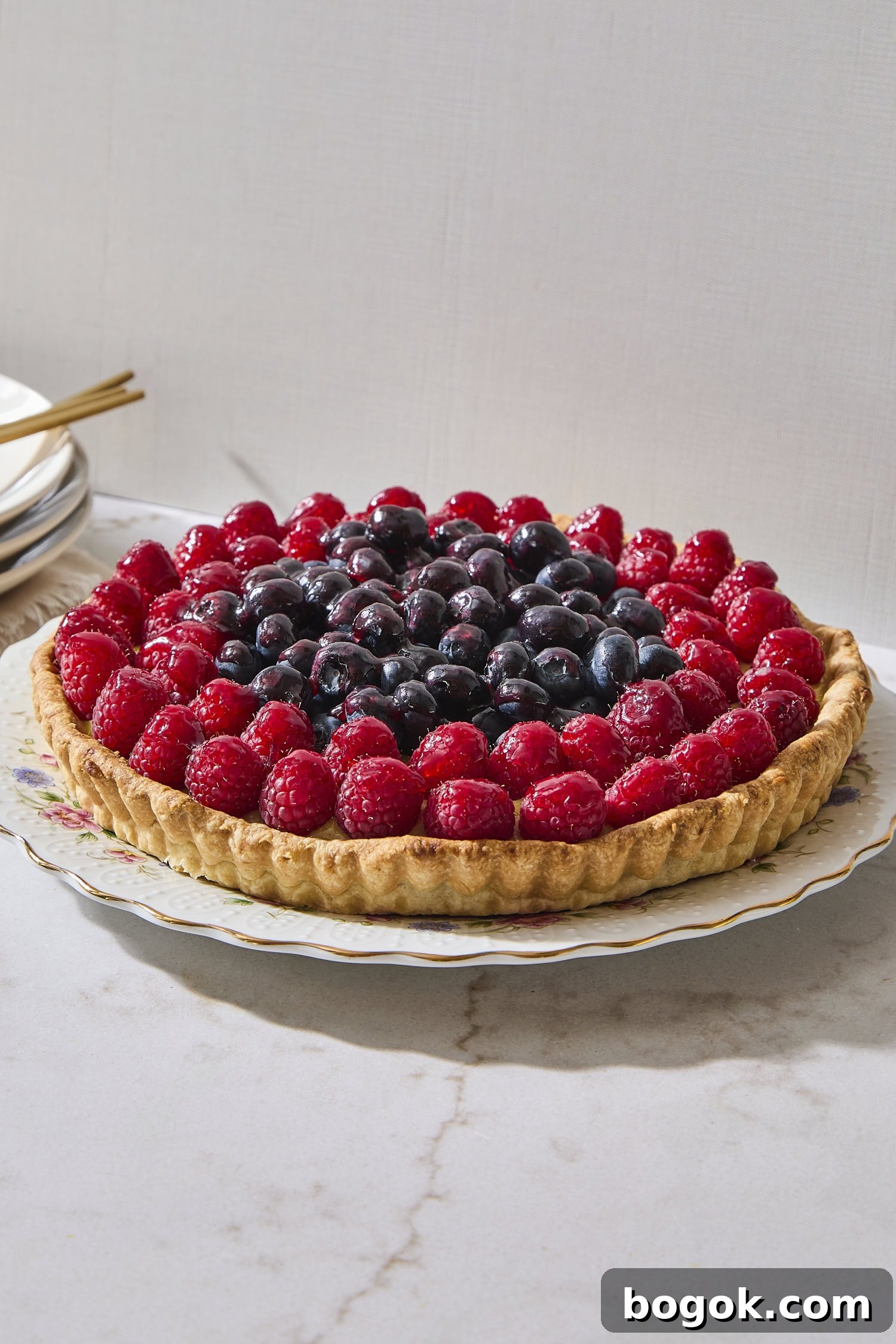 Fruit tart with blueberries and raspberries on top.