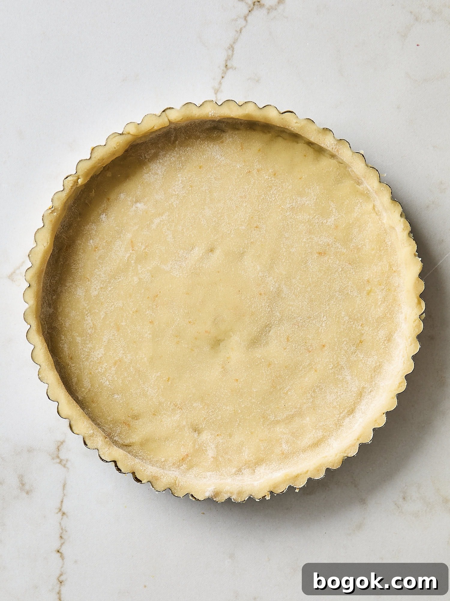 Pie dough fitted into a tart shell.