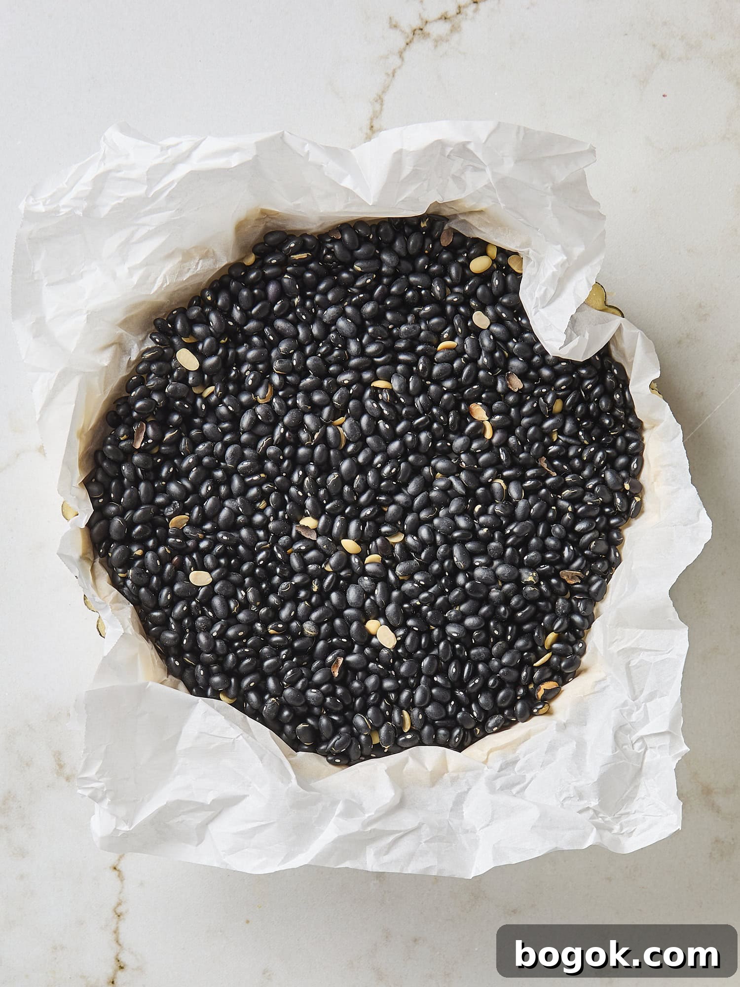 Baking beans in a tart shell for prebaking.
