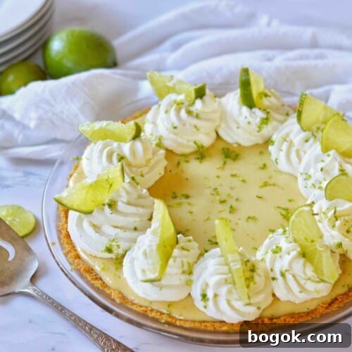 key lime pie w pie server and stack of plates