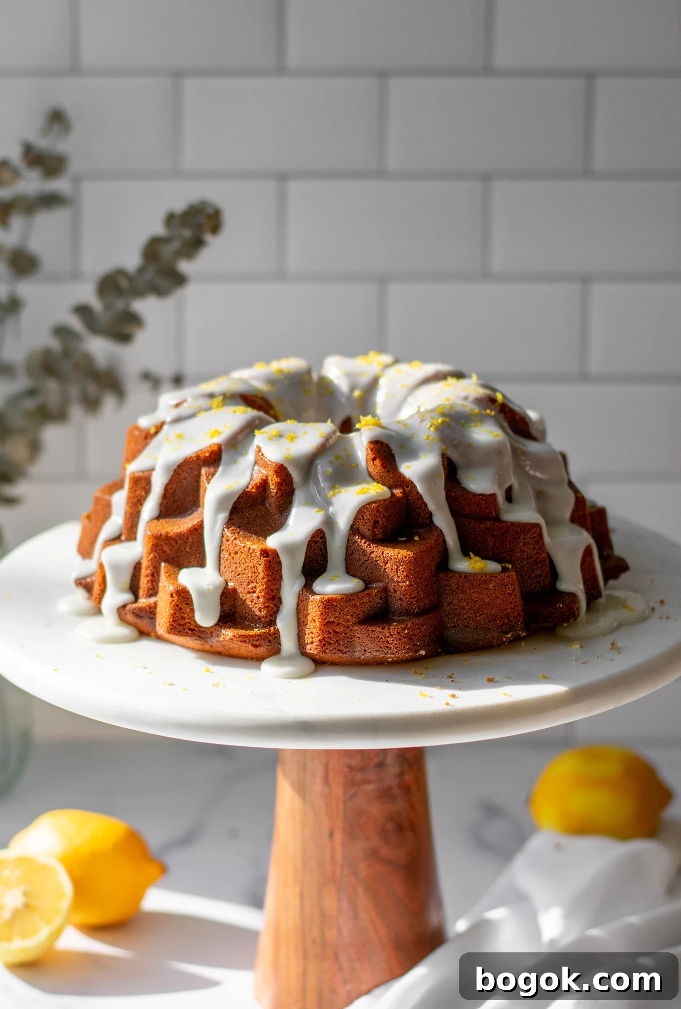 A lemon bundt cake on a cake stand.