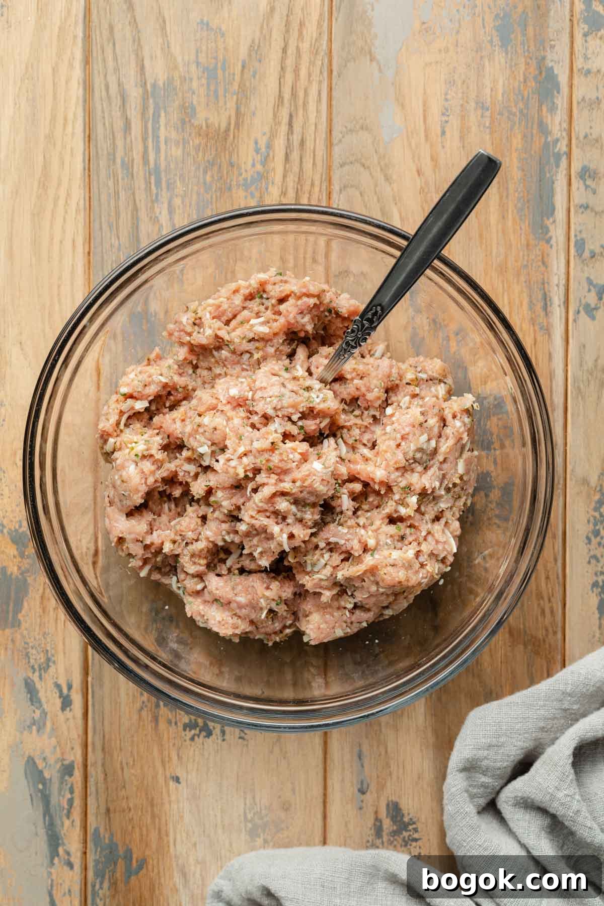 Crispy Air Fryer Turkey Meatballs with Garlic Herb Sauce 4 Turkey meatball mixture in a glass bowl.