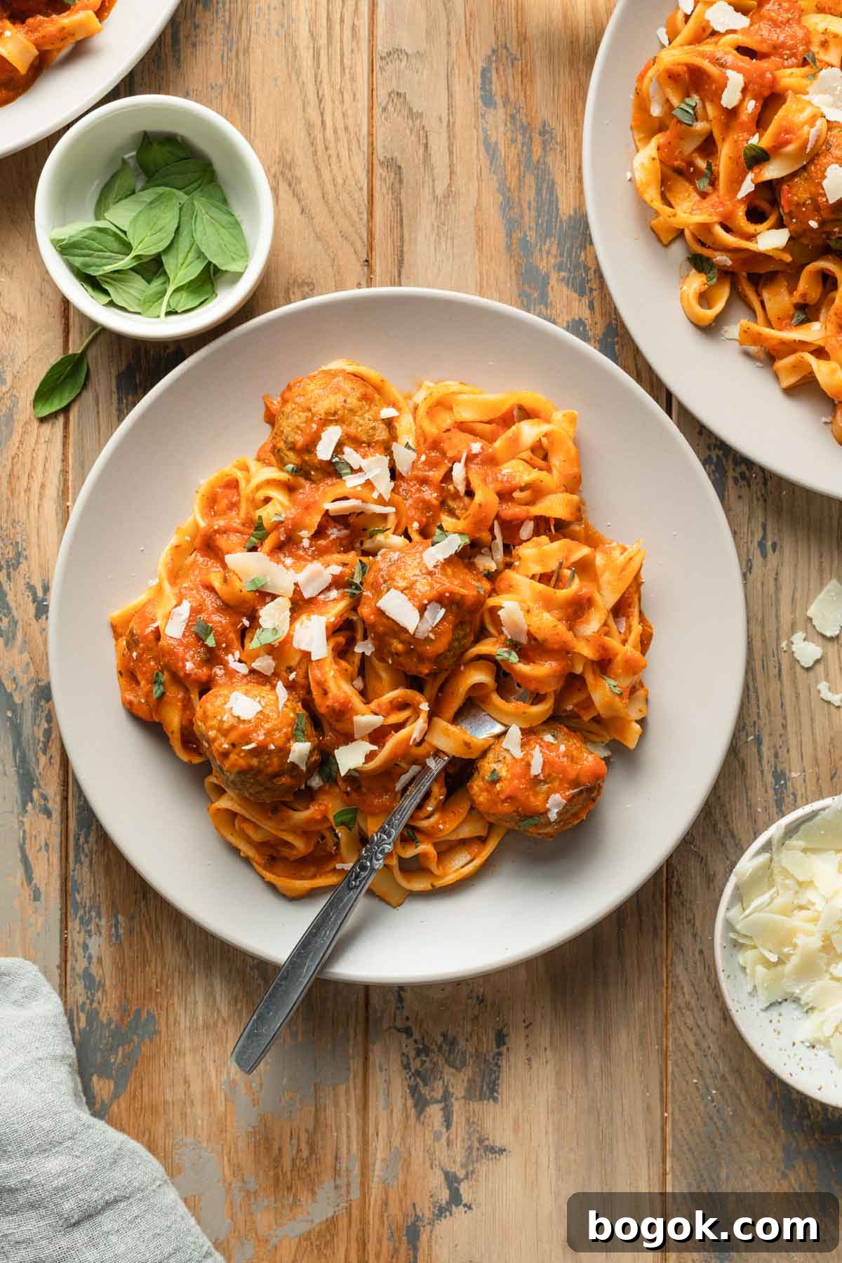 Crispy Air Fryer Turkey Meatballs with Garlic Herb Sauce 8 Turkey meatballs tossed with pasta and sauce on a plate.