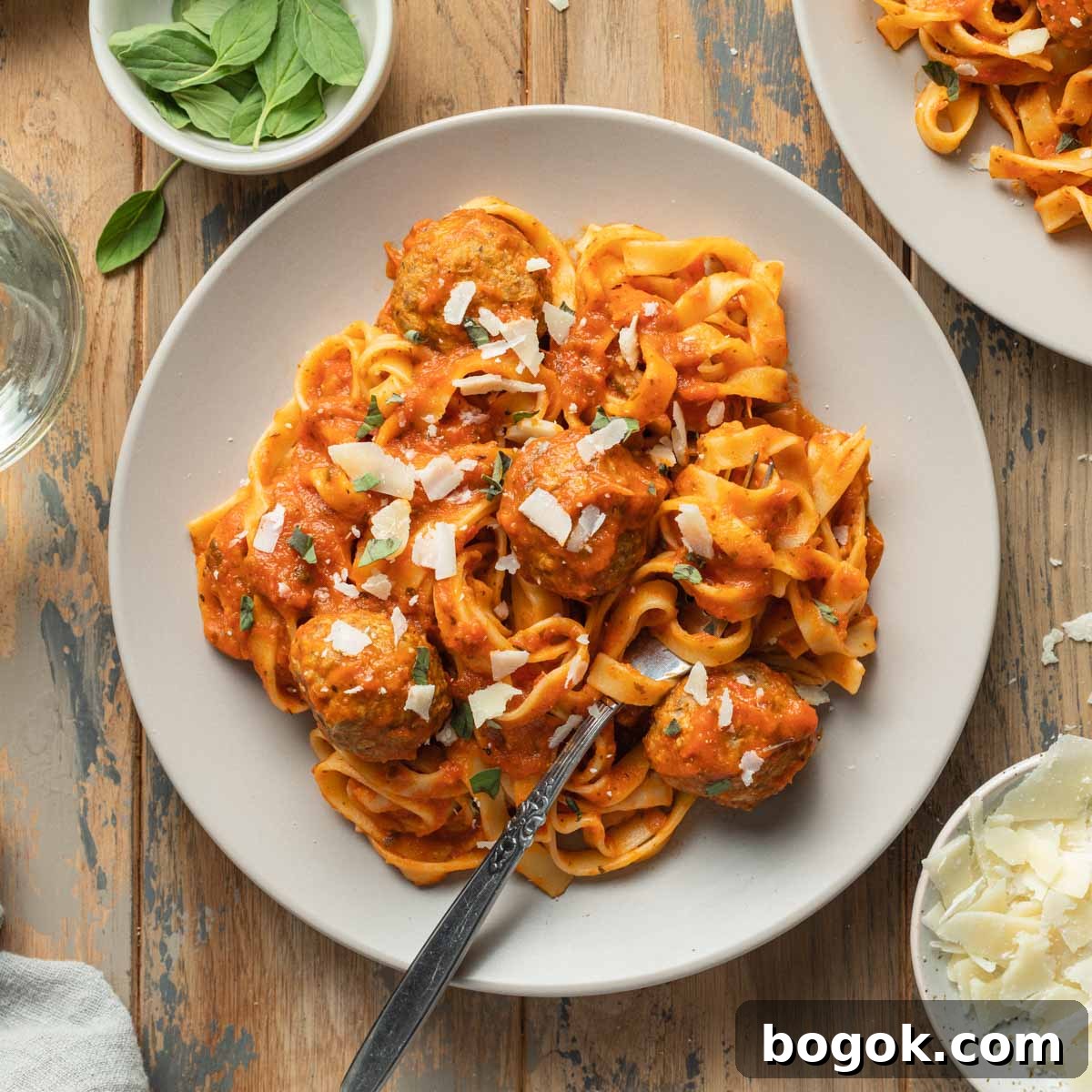 Crispy Air Fryer Turkey Meatballs with Garlic Herb Sauce 9 Air fryer turkey meatballs served on a plate with marinara sauce and pasta.