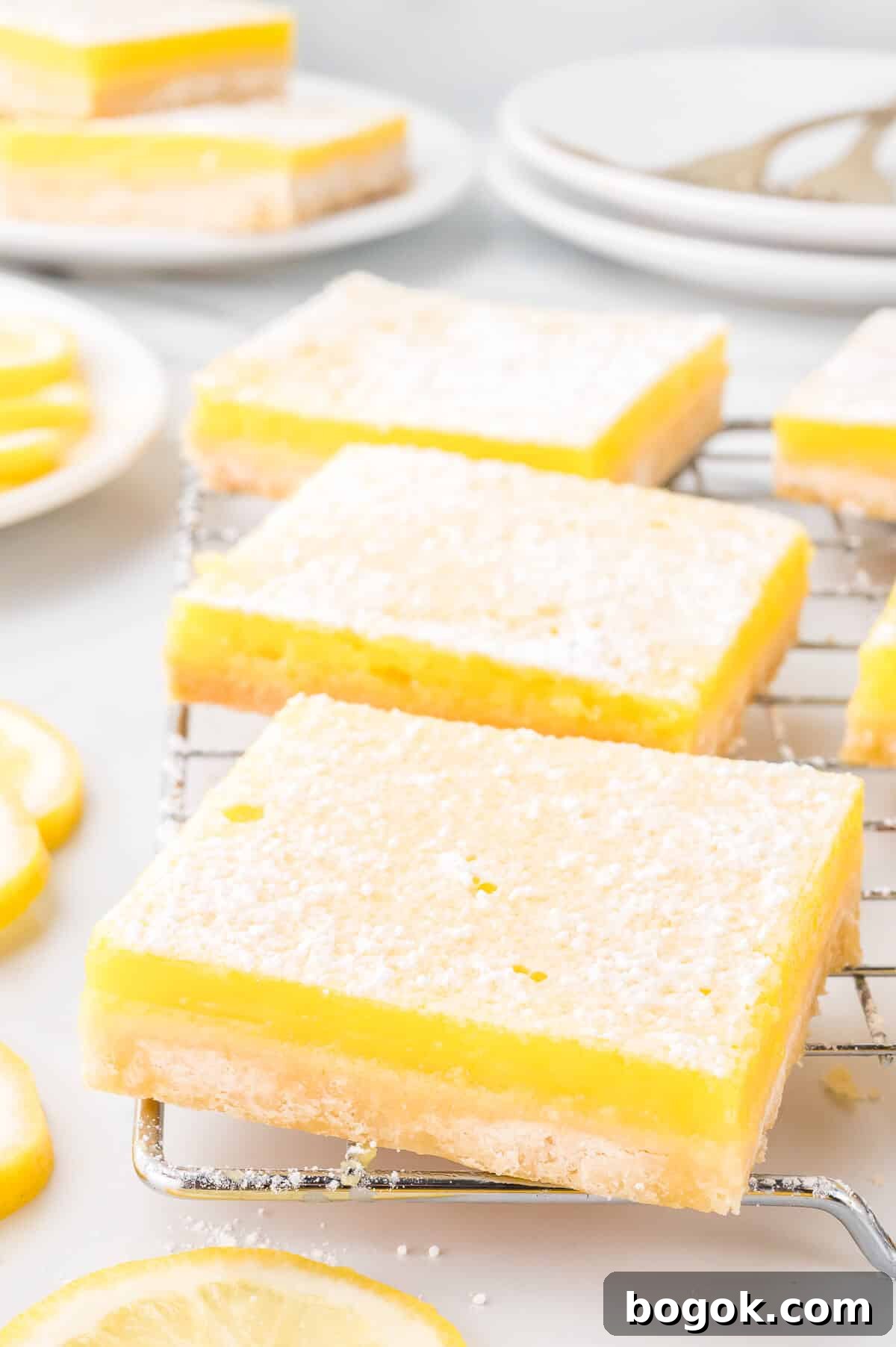 Classic Lemon Bars with Buttery Shortbread Crust 2 Lemon bars on a wire rack.