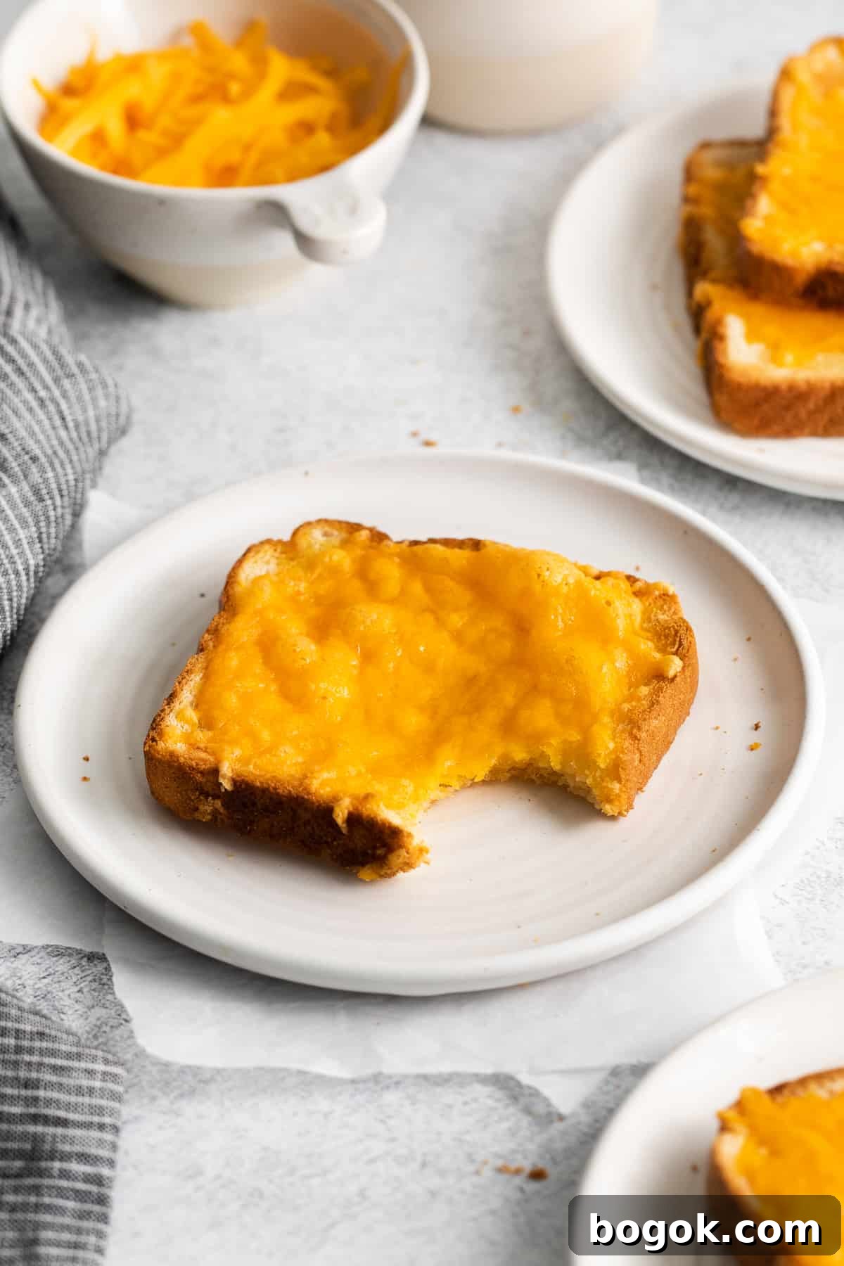 Cheese toast with a bite taken out Cheese toast with a bite taken out of it.