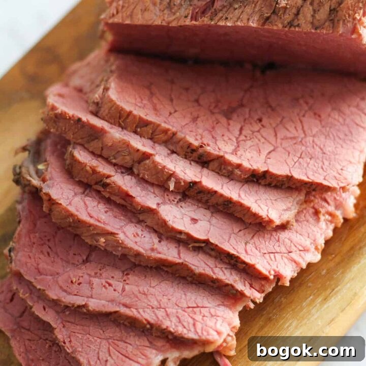 slices of corned beef on a wooden board.