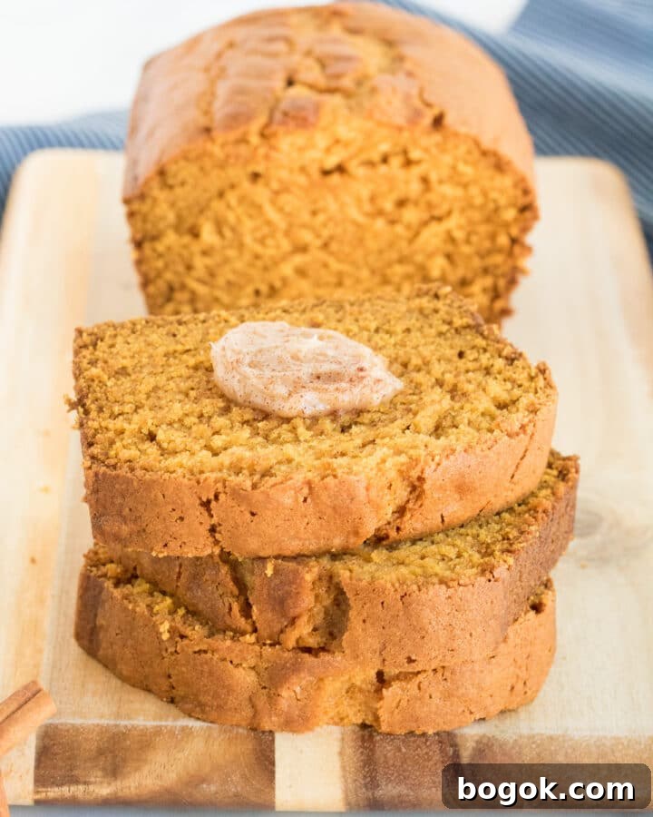 Gluten-free Pumpkin Bread sliced with cinnamon butter on the top slice.
