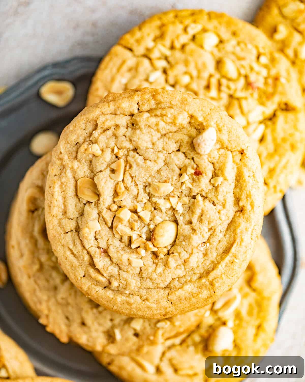 Chewy Peanut Butter Cookie Recipe for Perfect Texture 3 peanut butter cookies on a silver plate.