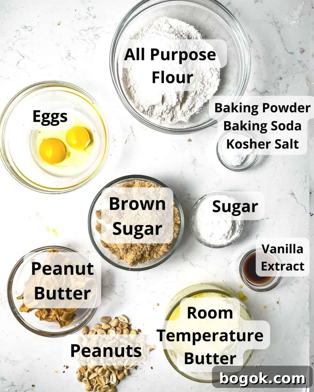 Chewy Peanut Butter Cookie Recipe for Perfect Texture 4 ingredients to make chewy peanut butter cookies - flour, butter, baking soda, baking powder, brown sugar, sugar, eggs, vanilla extract, peanut butter, salt, and chopped peanuts.